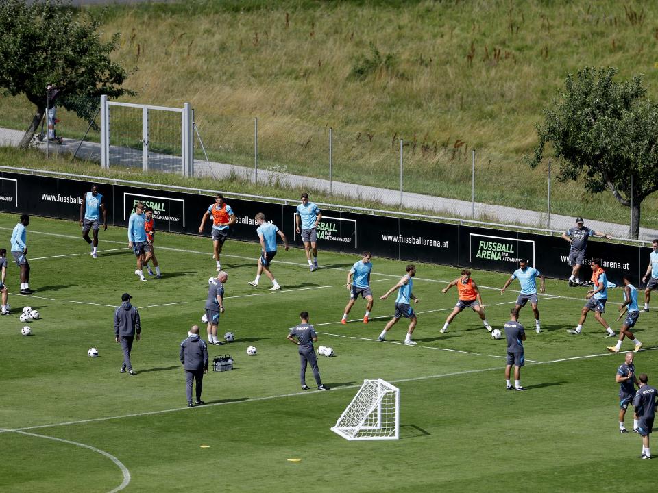 A general view of training from a vantage point with the pitch at the bottom of the hills
