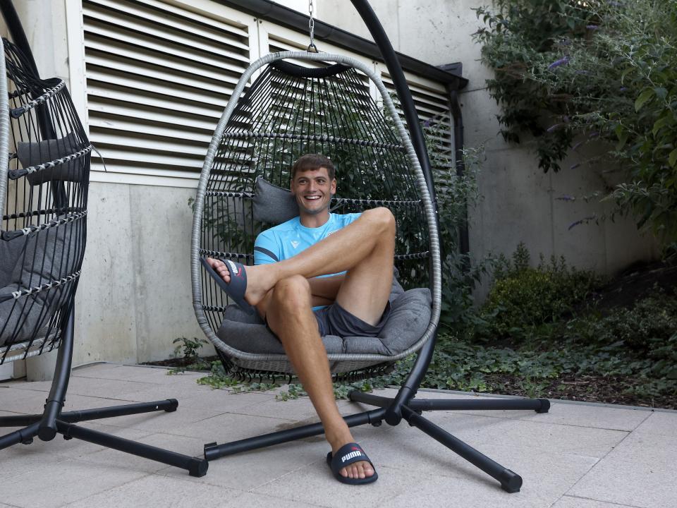 Caleb Taylor sat in a huge chair smiling