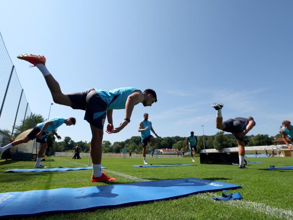 Several Albion players stretching before a training session