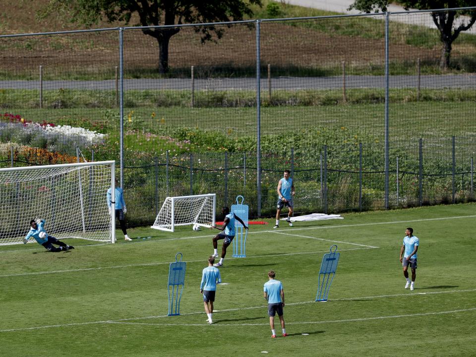 A general view of training from a vantage point with the pitch at the bottom of the hills