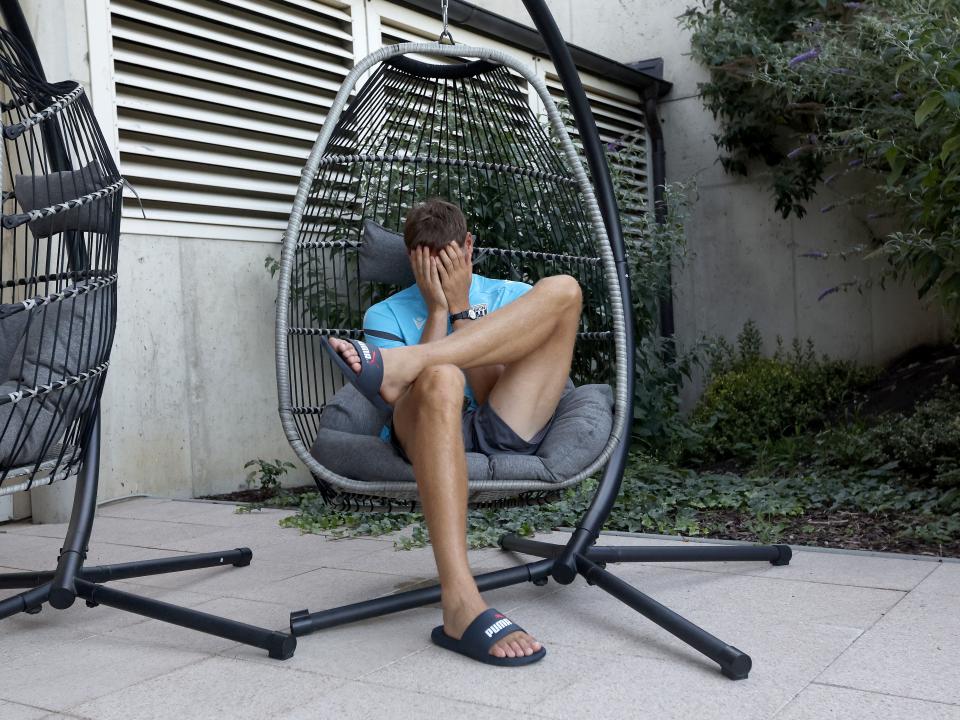 Caleb Taylor sat in a huge chair with his head in his hands 