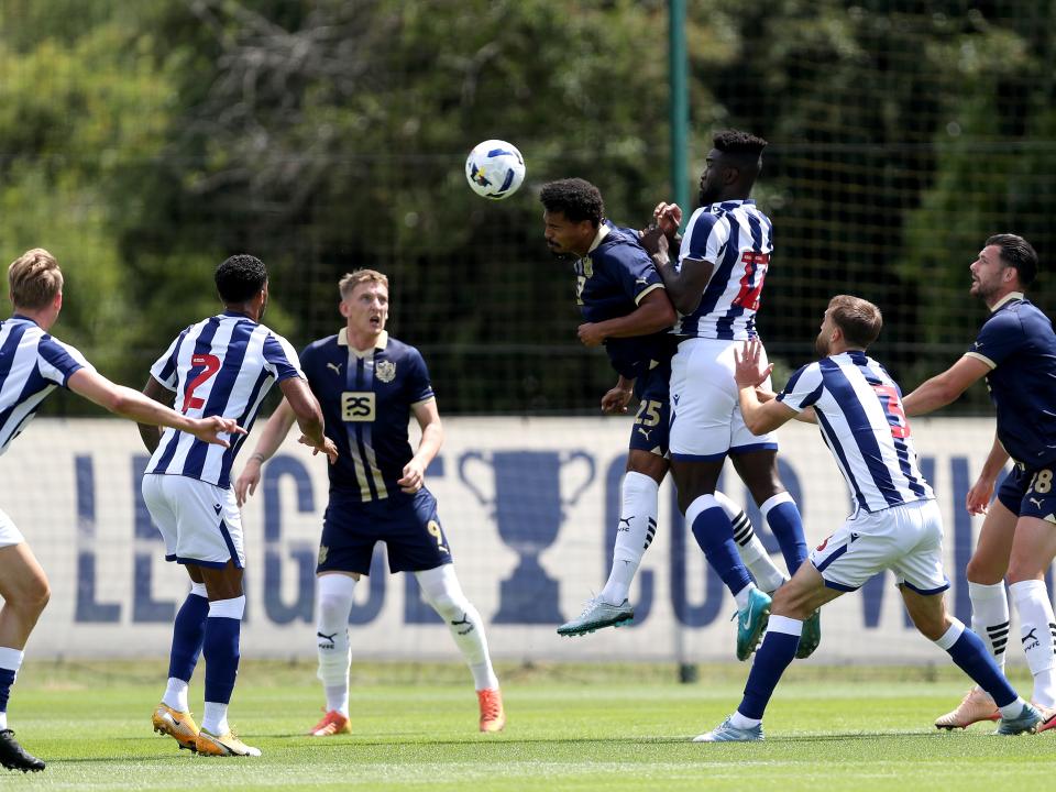 General match action with several players in shot of WBA v Port Vale 