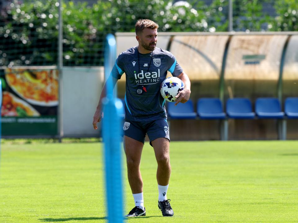 James Morrison watching a training session in Austria while holding a ball