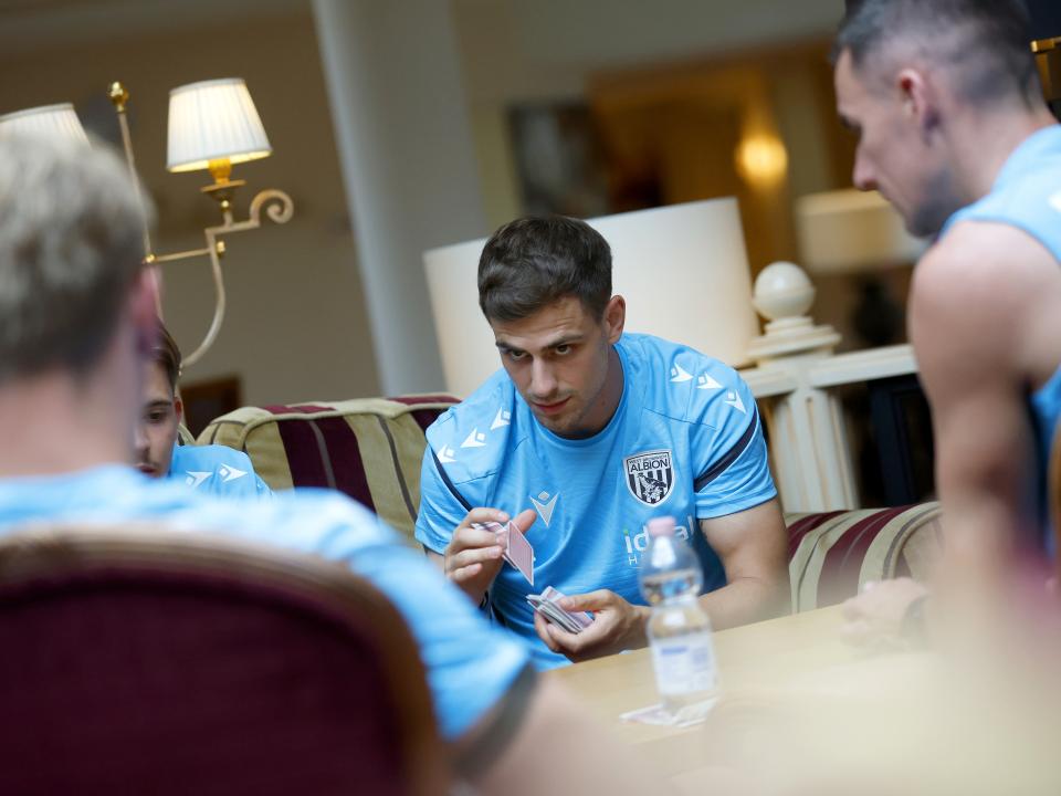 Jayson Molumby looking at his team-mates while playing cards