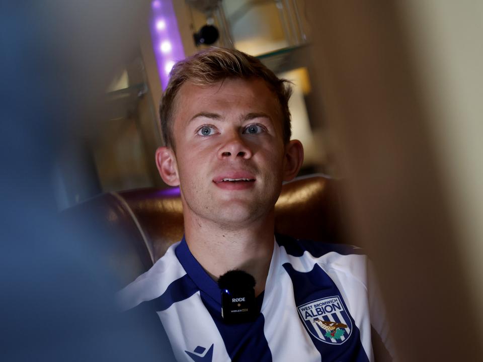 Aune Heggebø smiling while sat in a WBA shirt