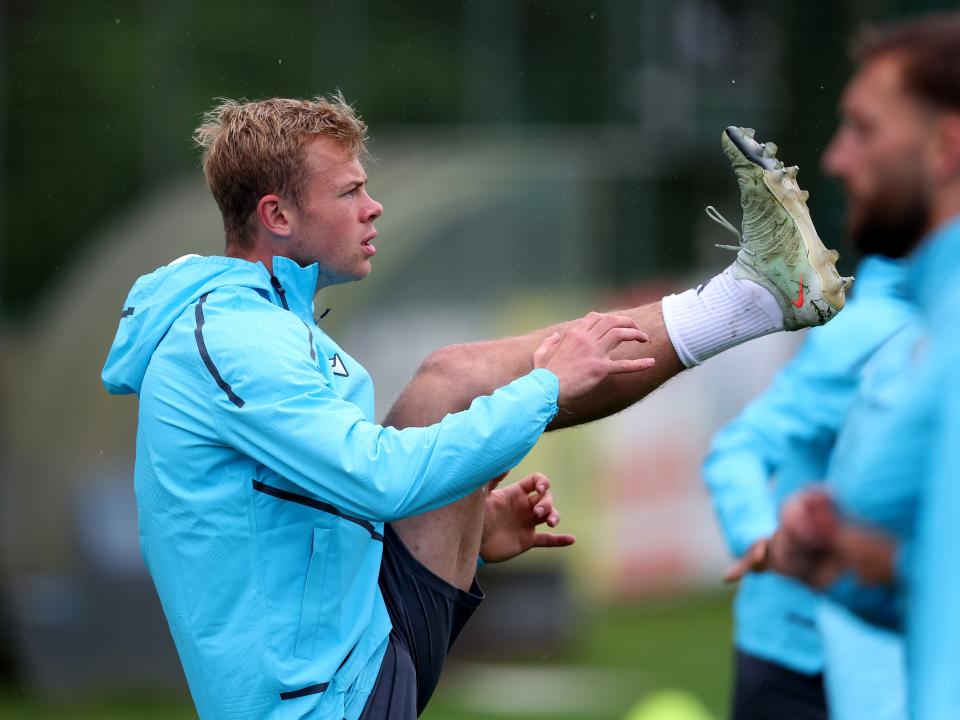 Aune Heggebø stretching during a training session in the rain