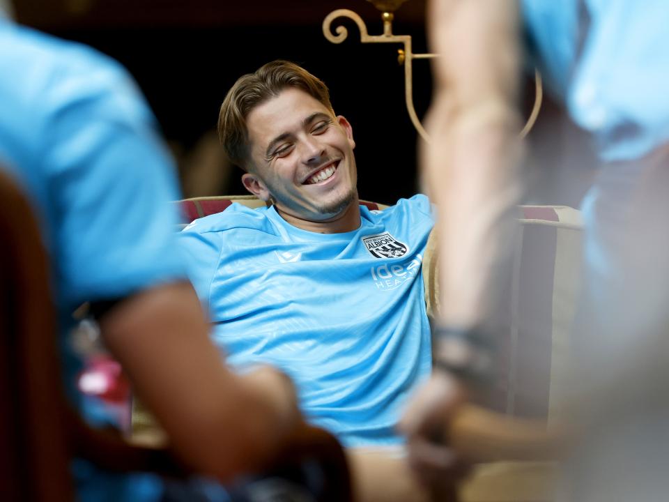 Isaac Price smiling while playing cards