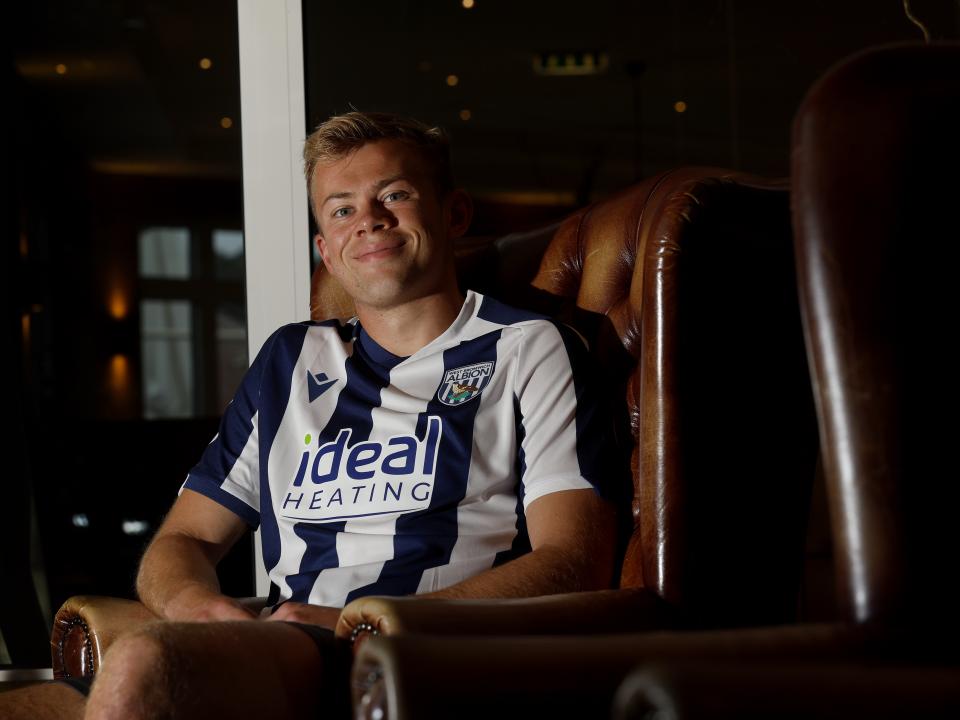 Aune Heggebø smiling at the camera while sat in a WBA shirt in a chair