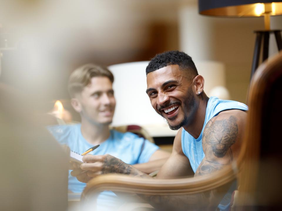 Karlan Grant smiling while playing cards