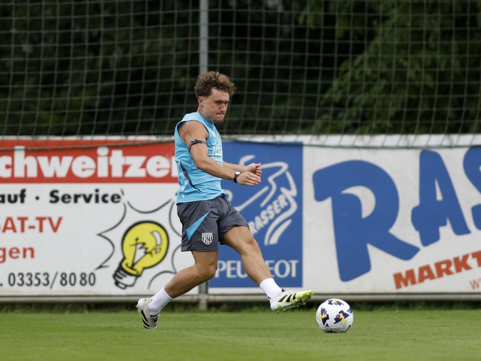 Callum Styles crossing the ball during a training session in Austria