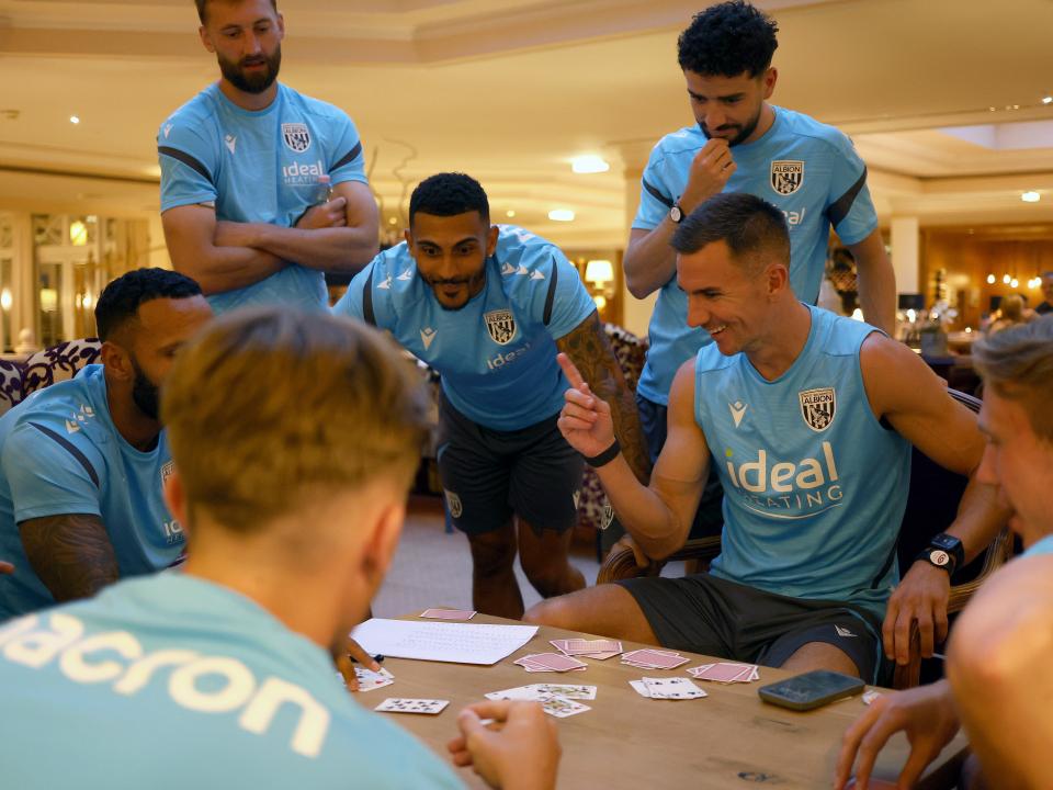 Several Albion players playing cards at a table