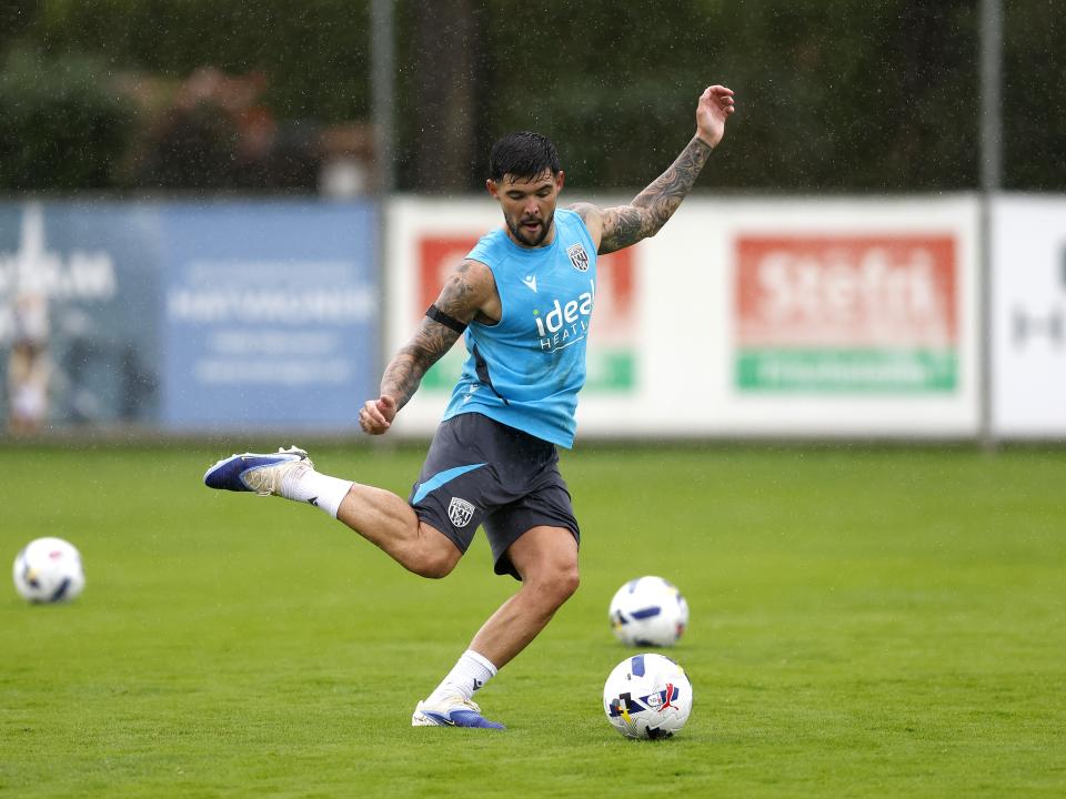 Alex Mowatt striking the ball during a training session in the rain