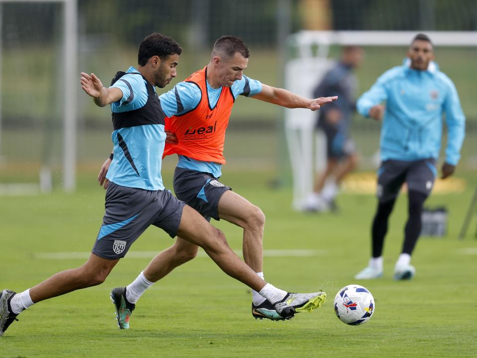 Gianluca Frabotta and Jed Wallace fighting for the ball during a training session in the rain