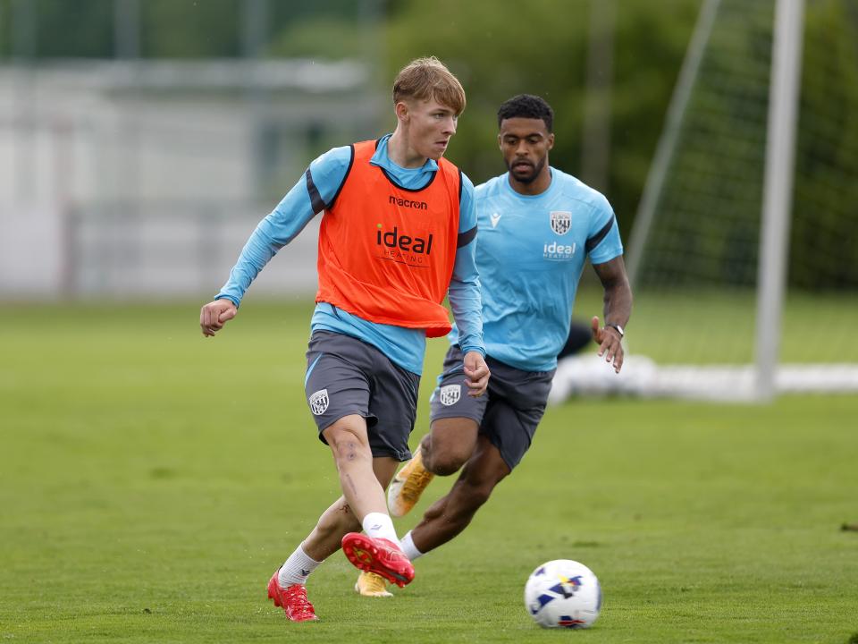 Ollie Bostock on the ball during a training session in the rain