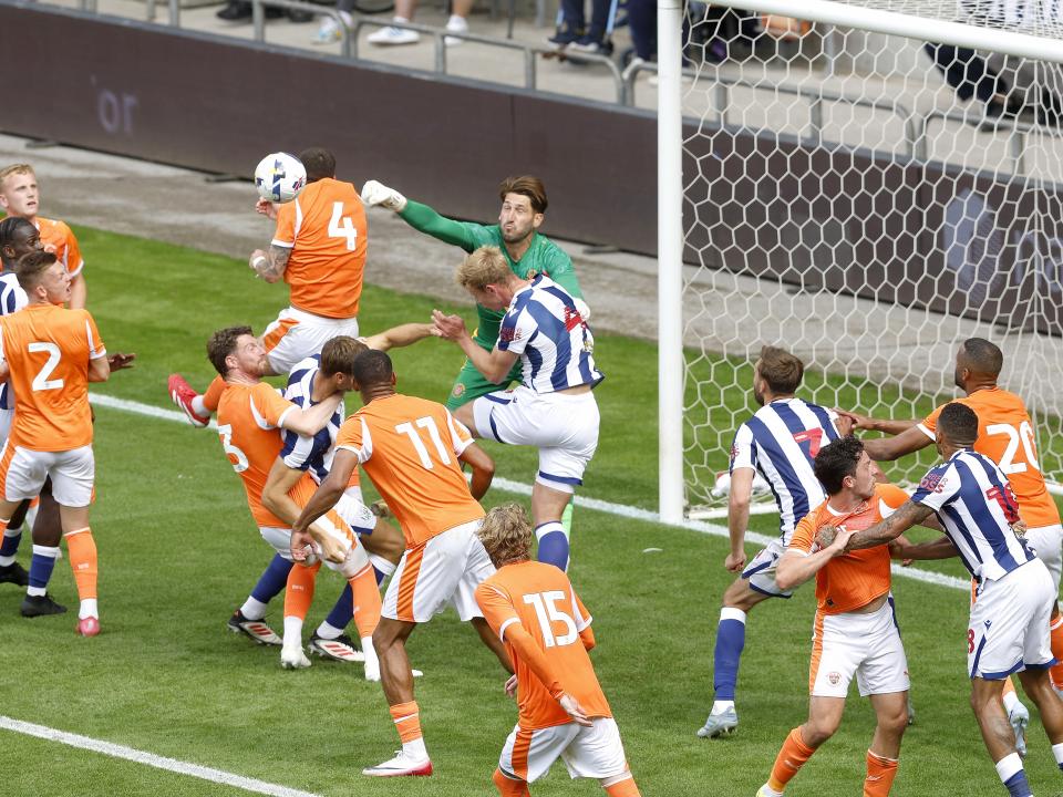 General match action of Blackpool v WBA with several players in the box jumping for the ball