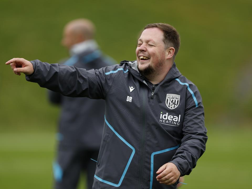 Albion medical staff member Dave Rafferty smiling and pointing on the training pitch 