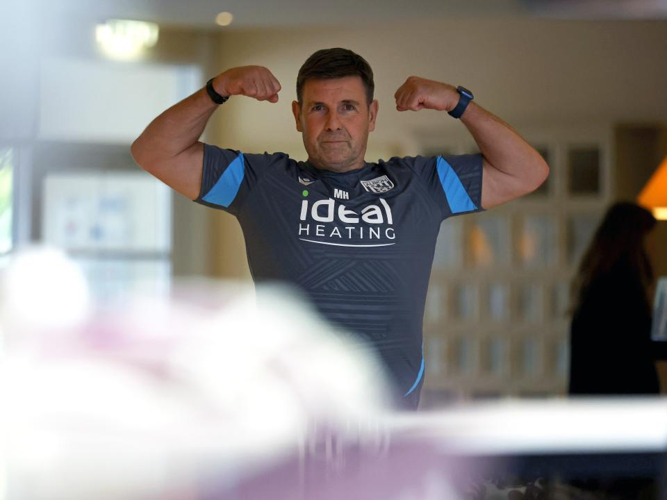 Albion medical staff member Micky Holland showing off his biceps in the hotel