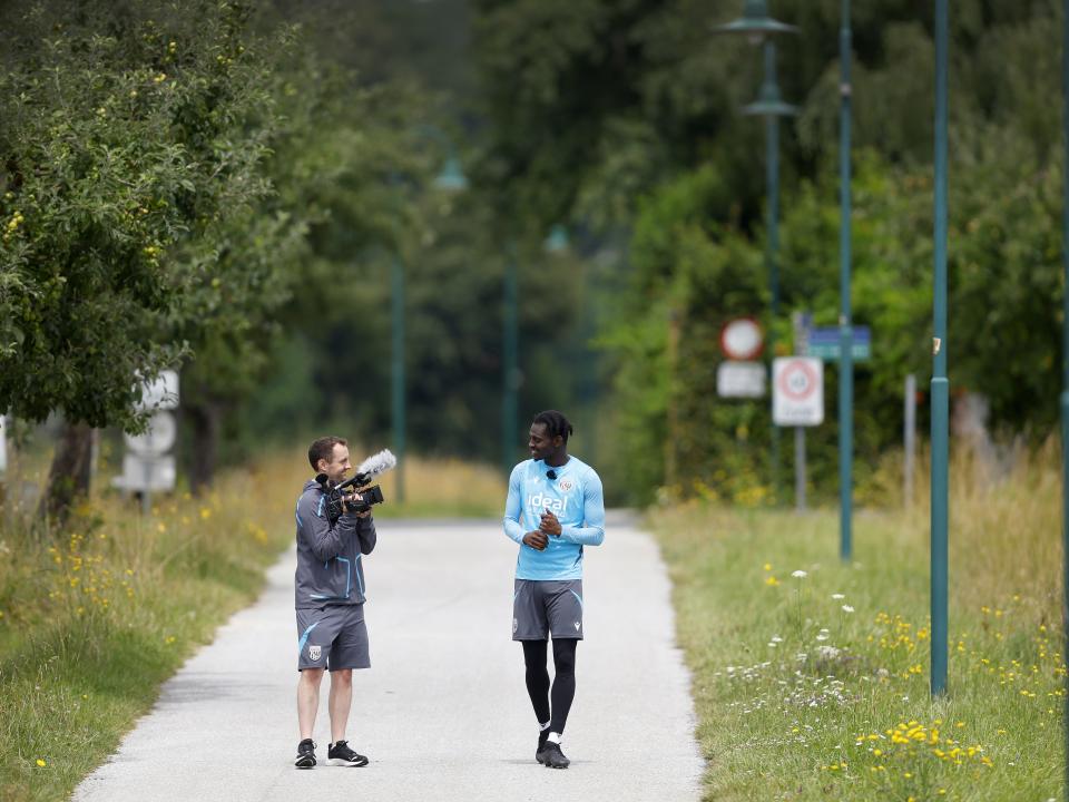 Albion cameraman Joe Shepherd filming Ousmane Diakité on a long path in Austria 