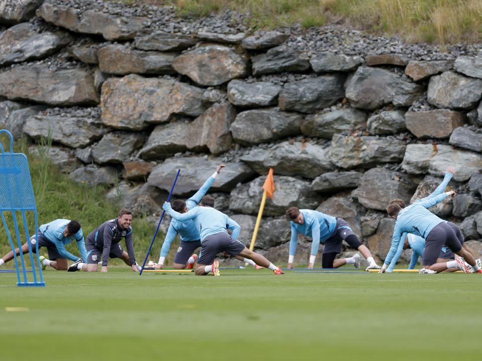 Albion goalkeepers warming up in front of several rocks