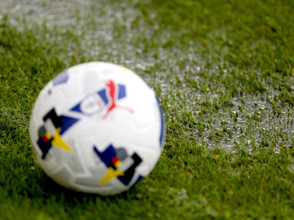 A general view of a rain puddle on the side of the pitch with a ball