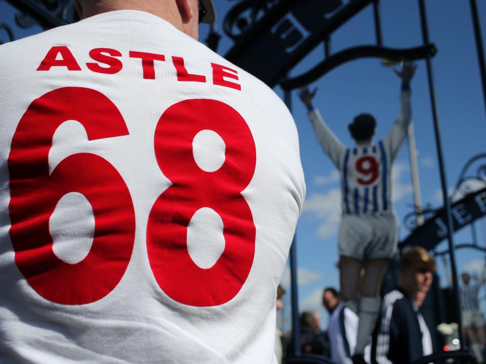 Astle 68 Shirt in front of Astle Gates