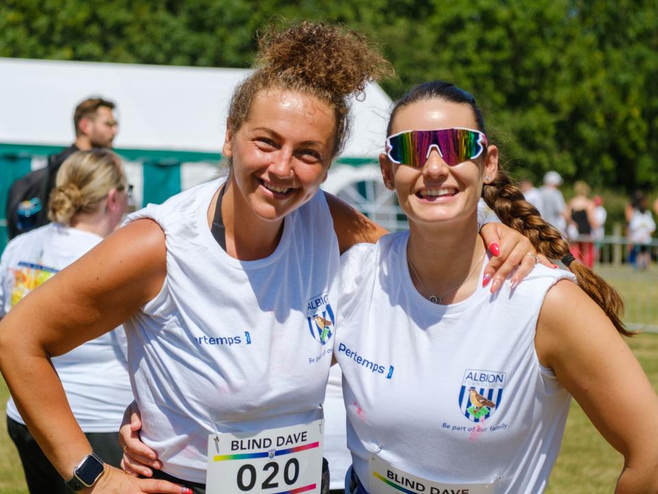 Two participants with arms around each other,