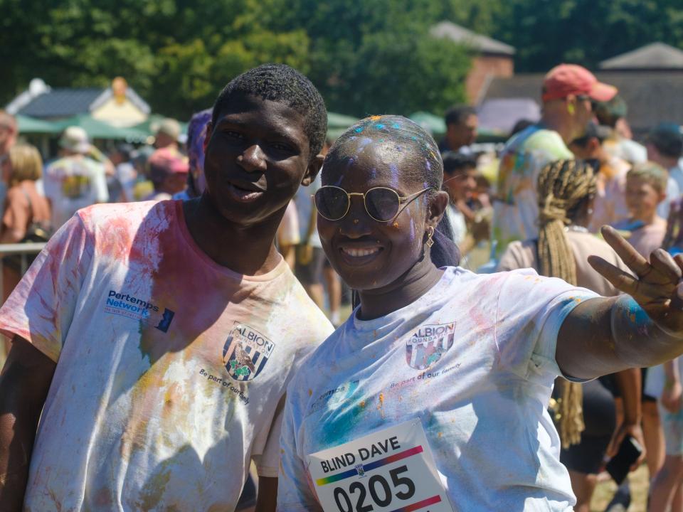 Two participants posing for a photo, one holding up the peace sign.