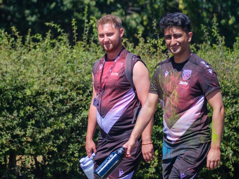 Two Foundation staff covered in paint.