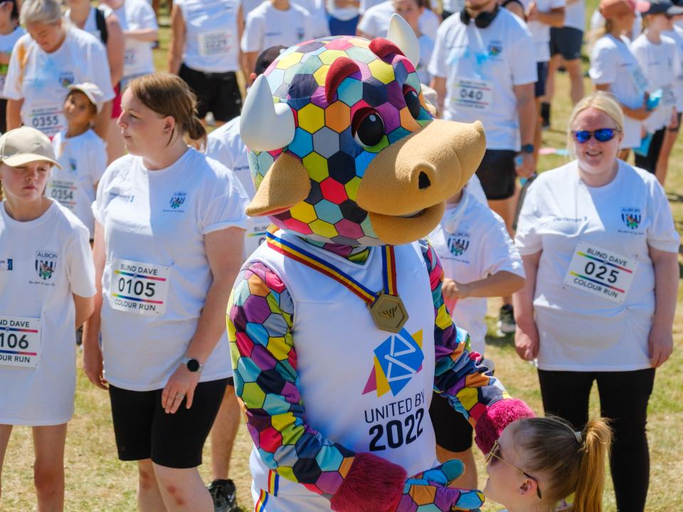 Perry the Bull engaging with participants in the warm up area.