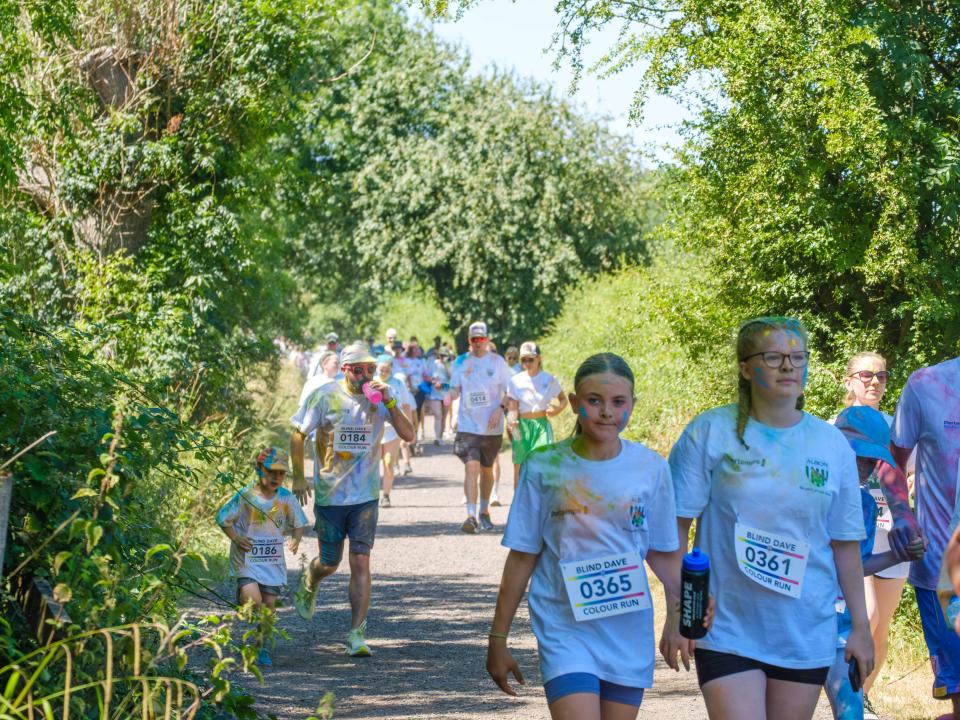 Participants walking through shaded greenery.