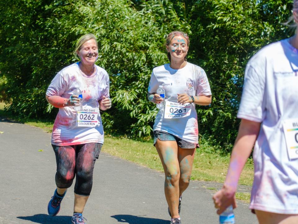 Mother and daughter running on the path.