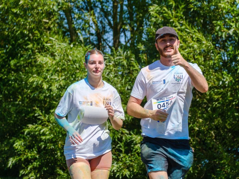 Close up of pair of runners, 0456 going the thumbs up.