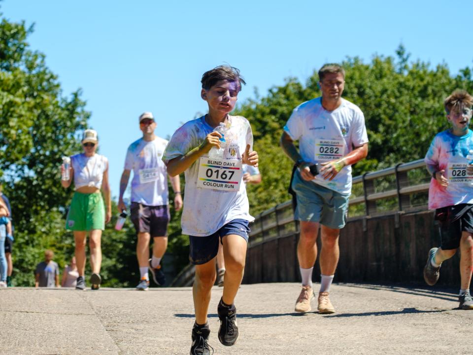 Runners crossing the motorway bridge.