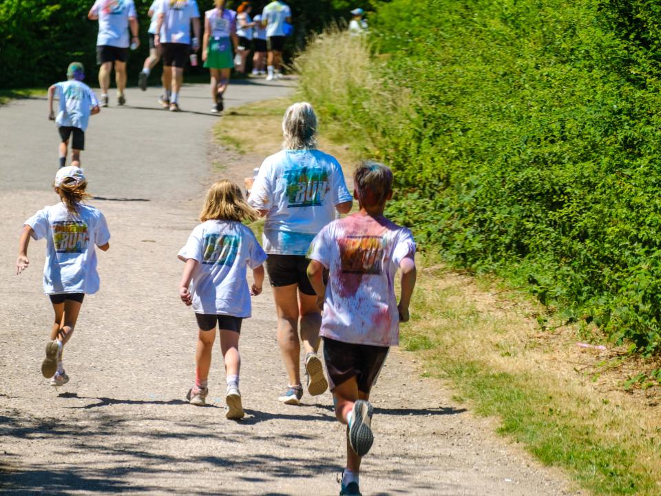 Backs of runners handing down the path.