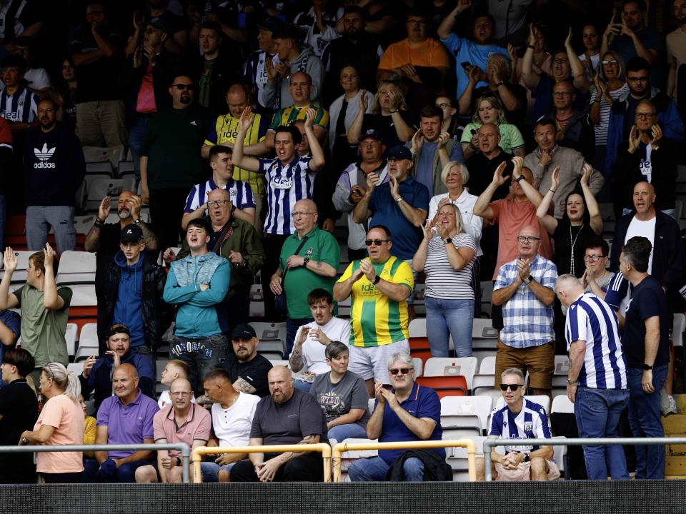 A photo of Albion supporters applauding the players at Lincoln