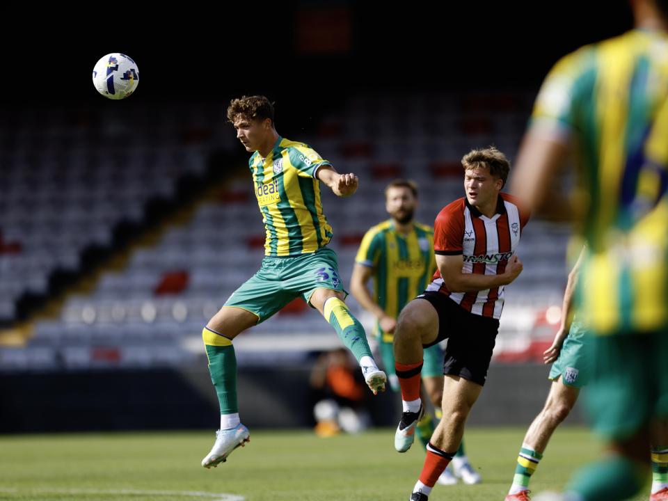 A photo of Cole Deeming in the 2025/26 green and yellow away kit