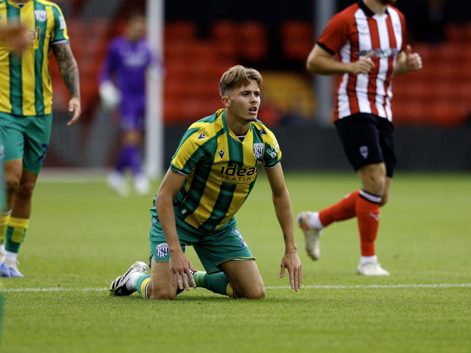 A photo of Isaac Price in the 2025/26 green and yellow away kit