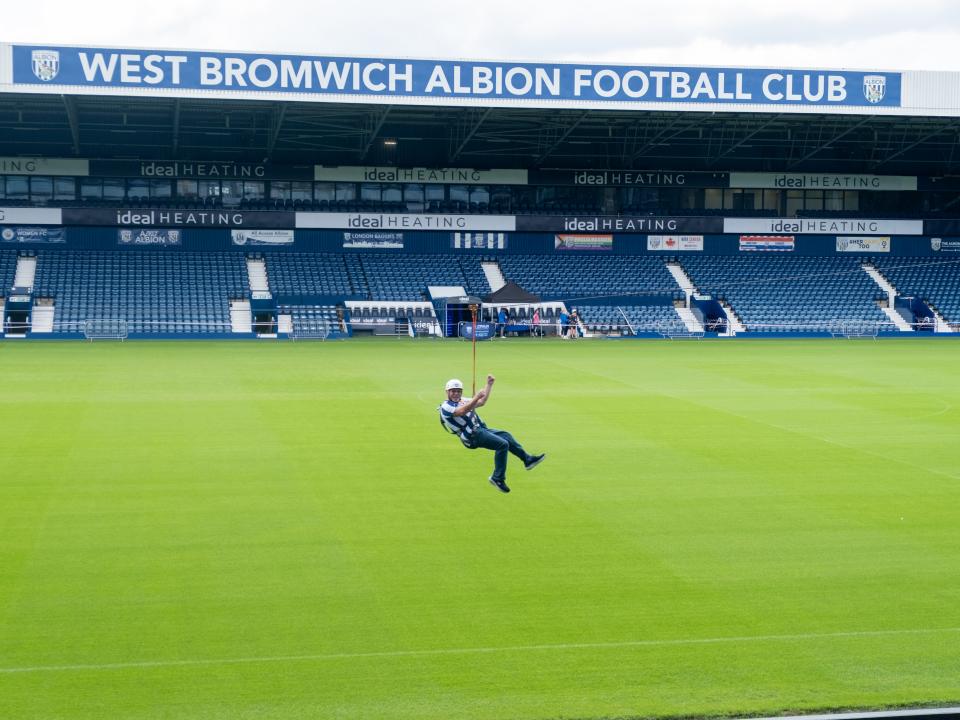 A participant zip wires across The Hawthorns.