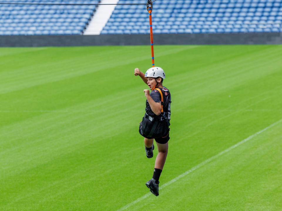 A participant zip wires across The Hawthorns.