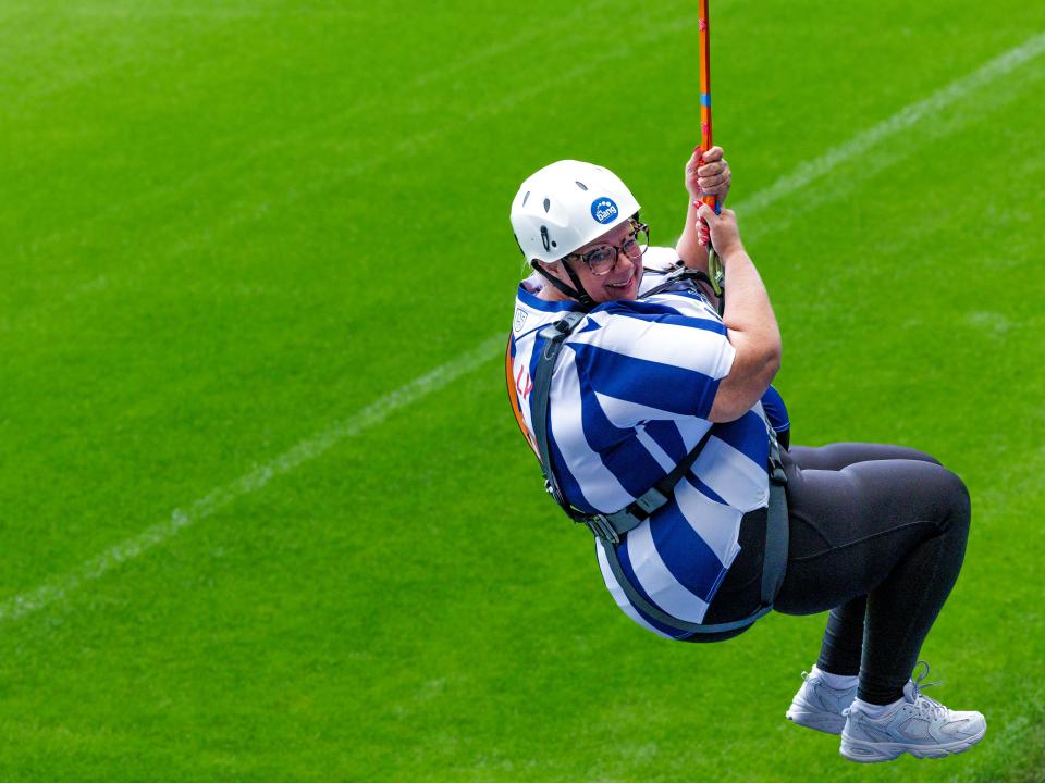 A participant zip wires across The Hawthorns.