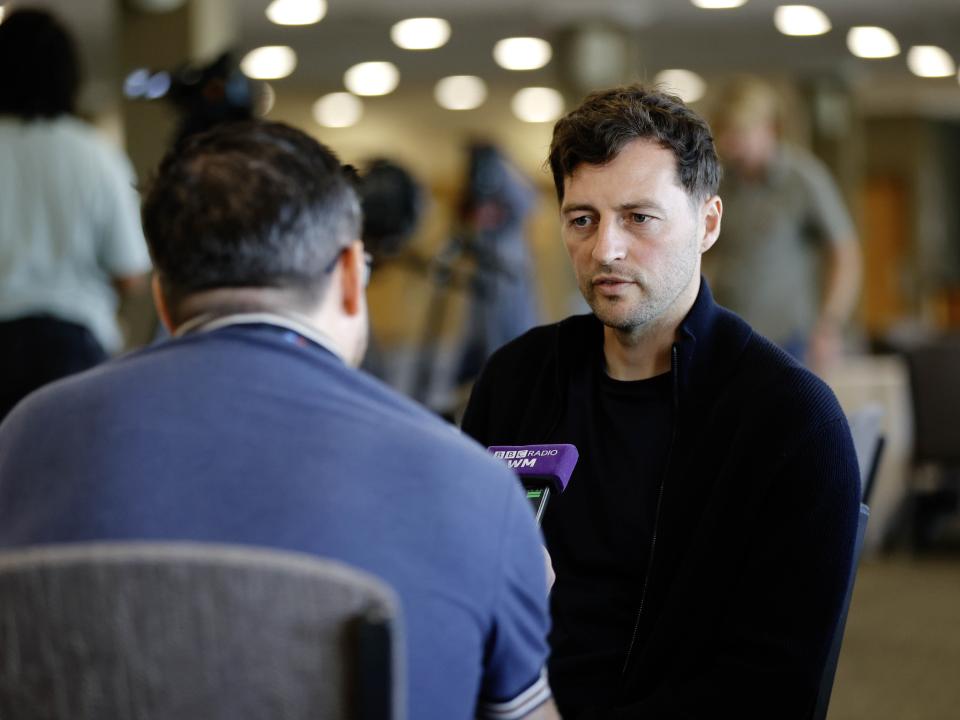 Ryan Mason talking to a radio reporter 