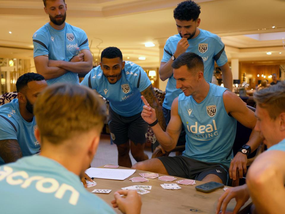 Several Albion players playing cards at a table at the hotel in Austria 