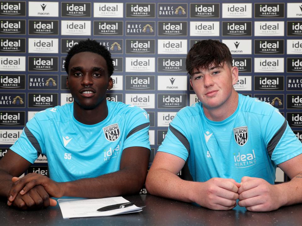 A photo of Dan Chimeziri and Louis Brady their professional contracts