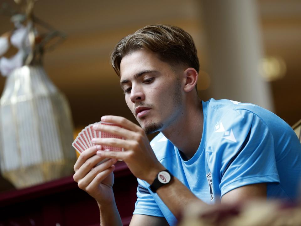 Isaac Price holding cards