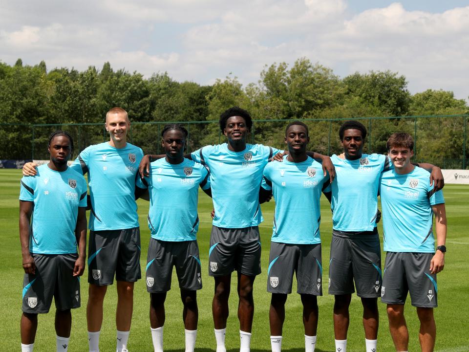 A photo of seven young Albion professionals standing together at the club training ground after extending their Baggies contracts
