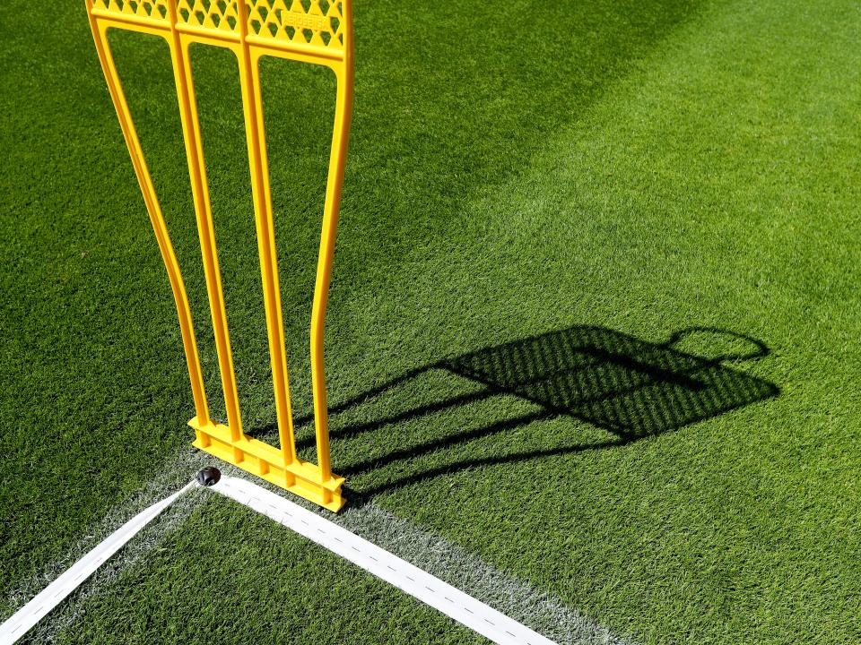 A photo of a yellow training dummy on the West Bromwich Albion training field