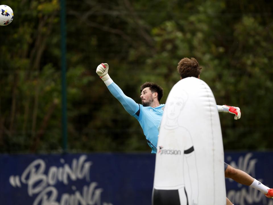 Joe Wildsmith punching a ball during a training session