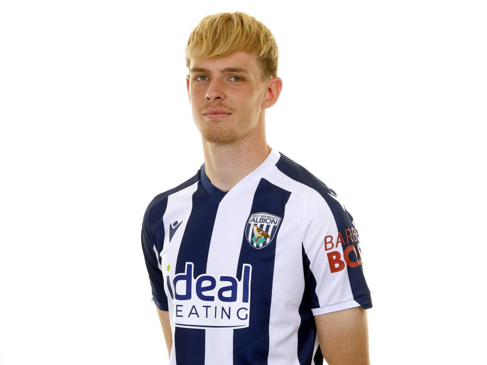 Toby Collyer smiling at the camera while wearing the home kit 