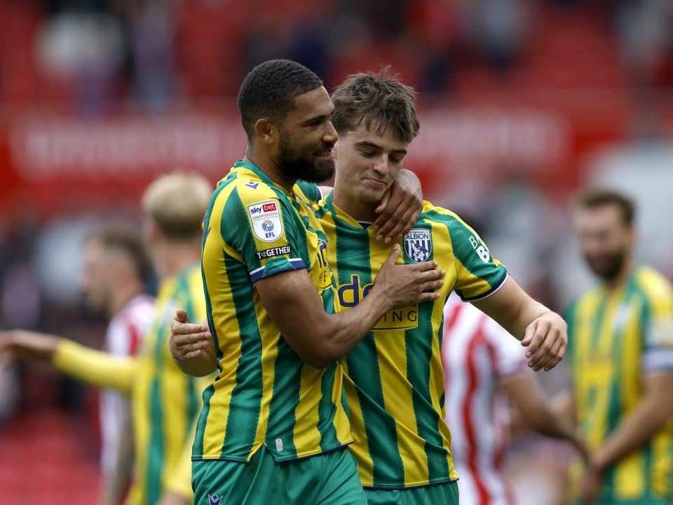 George Campbell and Alex Williams embrace after Albion's win at Stoke