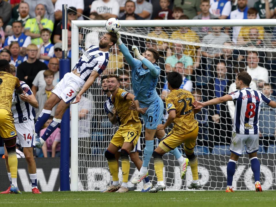 Nat Phillips trying to head the ball and Josh Griffiths trying to punch it away against Blackburn